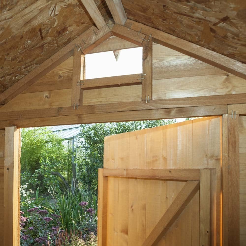 7x5 security shed interior with open door and garden view