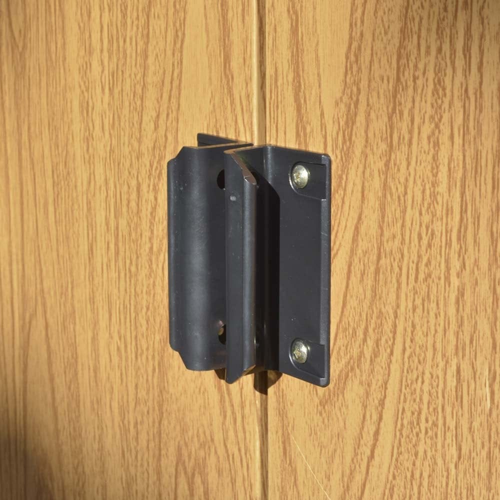 Metal shed door latch on wood panel