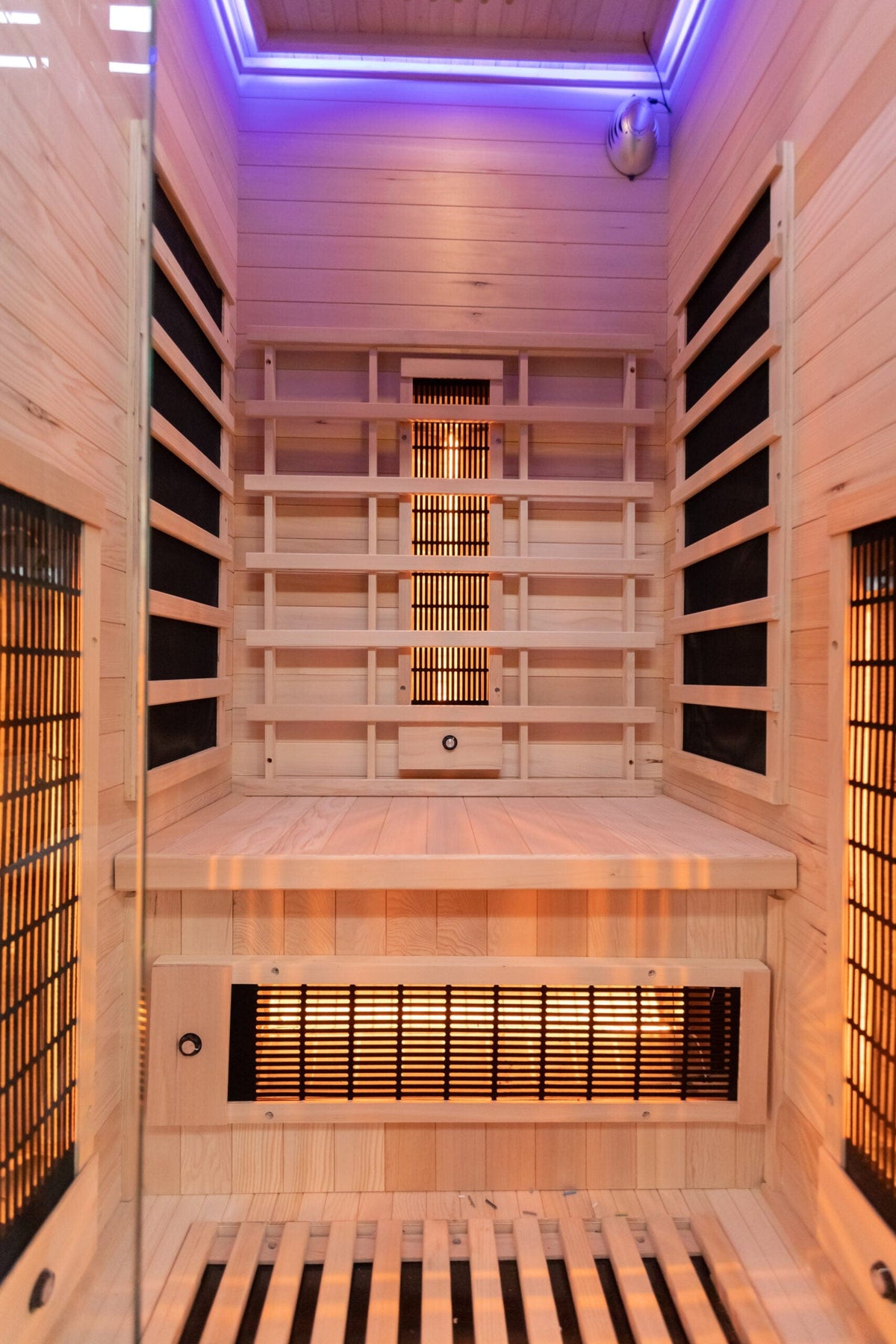 Inside view of wooden sauna with infrared heater